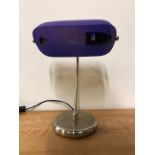 A contemporary desk lamp with blue shade