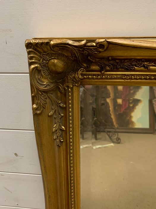 A gilt framed mirror with scrolling swags to corners - Image 2 of 2