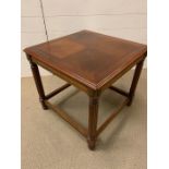 A Reproduction square table on reeded legs and stretchers 56 cm High x 53 cm High.