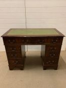 A pedestal desk with green leather top (H79cm W106cm D44cm)