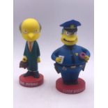 Two Simpson bobble head character toy figures.Comprising of Mr Burns and Chief Wiggum made by Funko.