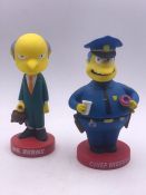 Two Simpson bobble head character toy figures.Comprising of Mr Burns and Chief Wiggum made by Funko.