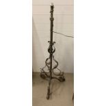 A wrought iron floor standing lamp