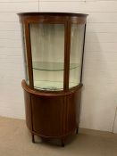 A bow fronted display cabinet with string inlay (H184cm W95cm D45cm)