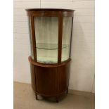 A bow fronted display cabinet with string inlay (H184cm W95cm D45cm)