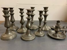 A selection of nine pewter candlesticks to include seven pillar (two pairs) two chamber candlesticks