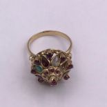 A Persian cocktail ring in untested gold setting with semi precious stones.