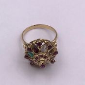 A Persian cocktail ring in untested gold setting with semi precious stones.