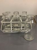 Six miniature glass bottles in wire carrying rack