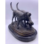 A bronze of a pair of hunting dogs on a marble plinth
