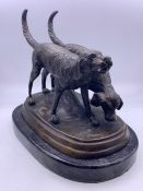 A bronze of a pair of hunting dogs on a marble plinth