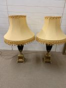 A pair of brass urn table lights