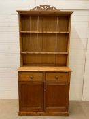 A pine dresser with plate rack/shelves to top and cupboard with drawers to base (H210cm W108cm