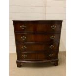 A bowfront chest of drawers with drop handles and bracket feet (H84cm W76cm D49cm)
