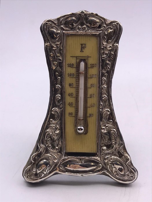 A silver framed thermometer (H10cm)