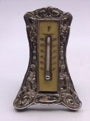 A silver framed thermometer (H10cm)