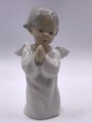 A Lladro figure of a kneeling angel