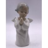 A Lladro figure of a kneeling angel