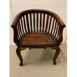 A Indian hardwood horse shoe armchair, the curved arms with scrolled arms