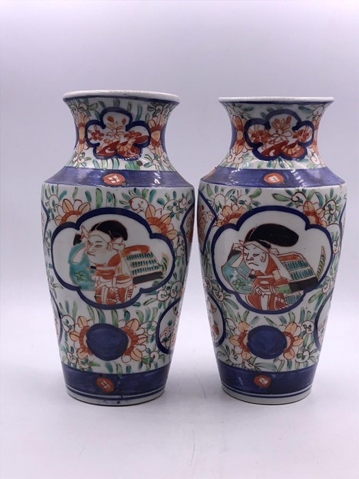 A pair of Amari vases, decorated with figures to sides