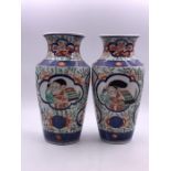 A pair of Amari vases, decorated with figures to sides