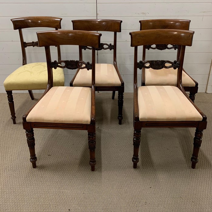 A set of four regency style dining chairs, shaped rectangular backs, carved pierced splats and