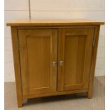 A small oak two door cupboard (H65cm W65cm D33cm)