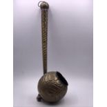 A Hammered antique measure or ladle.