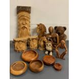 A selection of turned wood items to include carved horses, bookends and lidded pots
