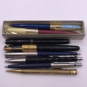 A small collection of pens, various makers