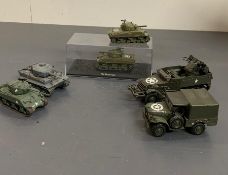 Four military tanks and two military vehicles