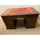 A mahogany pedestal desk with red leather top and drawers to side (H76cm W137cm D81cm)