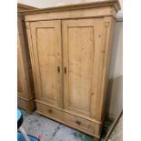 A two door pine wardrobe with two drawers under (H185cm W128cm D60cm)