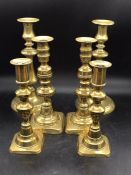 Three sets of brass candles sticks