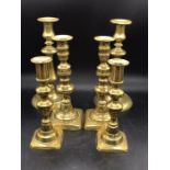 Three sets of brass candles sticks