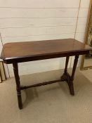 A Mahogany serving table on castors