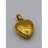 An untested gold metal heart shaped locket