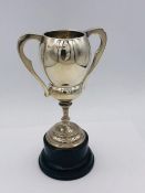 A Hallmarked silver trophy, engraved on stand. (84g)