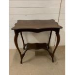 A mahogany side table with scrolled edge and shelf under (H76cm W77cm D50cm)