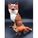 A large Beswick fox (31cm) along with a small standing Beswick fox (H13cm W23cm)