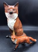 A large Beswick fox (31cm) along with a small standing Beswick fox (H13cm W23cm)