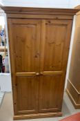 A two door modern pine wardrobe (H182cm W98cm D59cm)