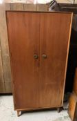 A Mid Century wardrobe with hanging space to side and shelves to other