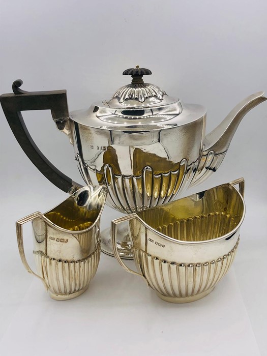 A Three piece hallmarked, harlequin tea service (Approximate weight 980g) various hallmarks and