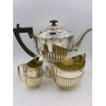A Three piece hallmarked, harlequin tea service (Approximate weight 980g) various hallmarks and