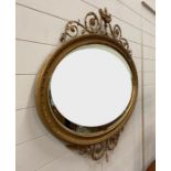 A George IV style giltwood over mantle mirror surmounted by an urn with swags and finials