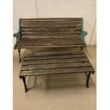 A garden bench with wooden slat seating and metal ends along with a similar style table (H72cm