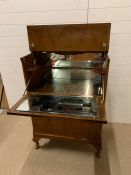 A Mid Century cocktail cabinet with original cocktail sticks and mirror lining