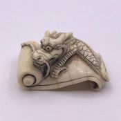 An Ivory Netsuke, signed to base.