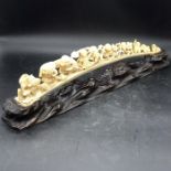 An Antique Ivory carved tusk on stand signed to base.